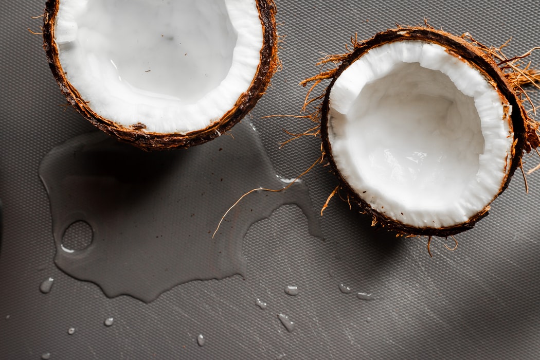 coconut split in half with coconut water